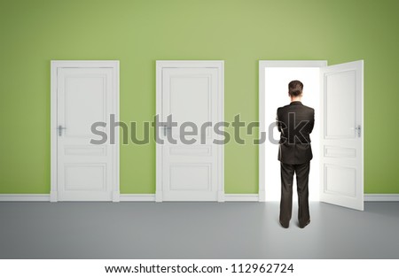 businessman in green room with three door