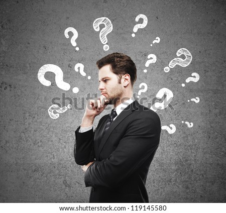 man having questions and concrete wall