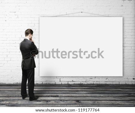man looking empty poster on wall