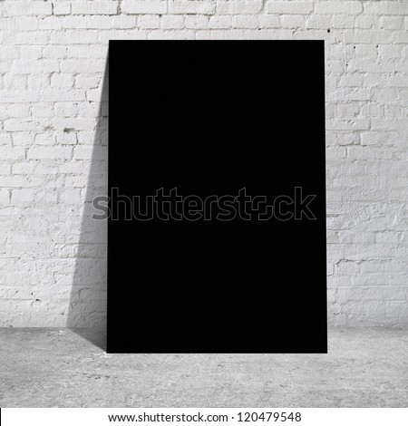 black table standing next to a brick wall