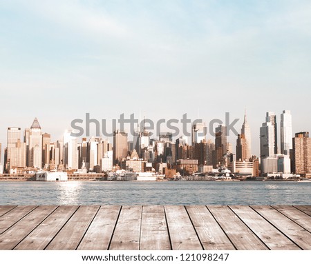 wooden pier before modern city