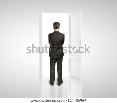 man in white room with doors open