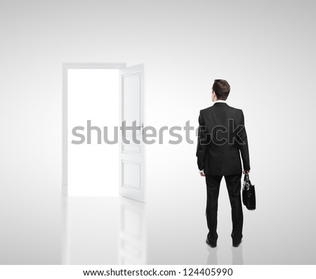 businessman in white room with doors open