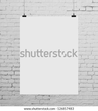 brick wall with white poster