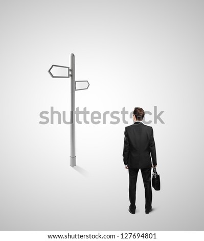 businessman looking at direction indicator