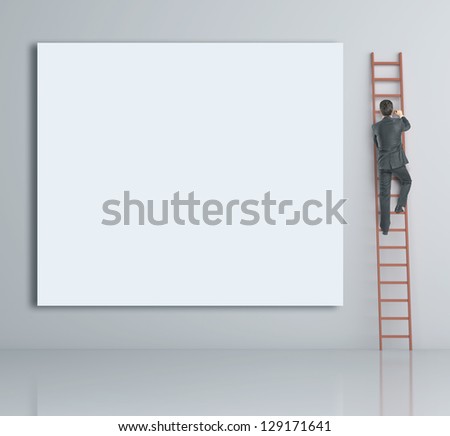 man climbing on ladder and blank poster