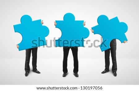 three man holding blue puzzle card