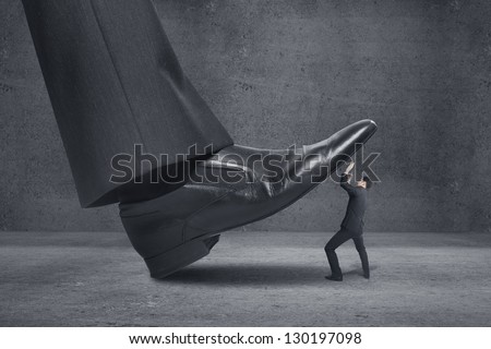 big foot stepping on businessman