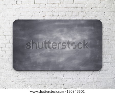 Black blackboard on brick wall
