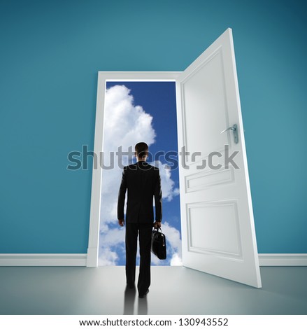man with briefcase open door to blue sky
