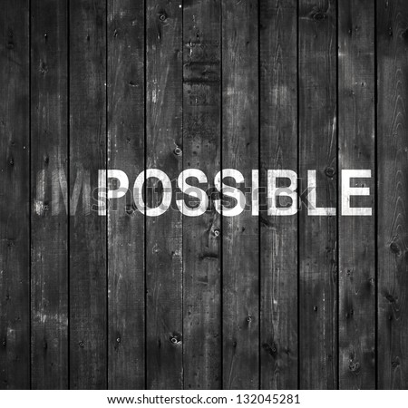 impossible text on gray wooden wall - stock photo