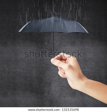 hand holding a small umbrella and rain
