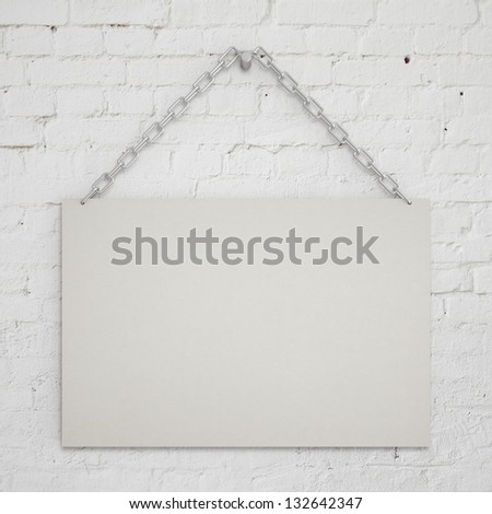 blank poster hanging on a chain on wall