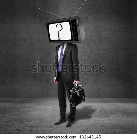 businessman with tv head on concrete room