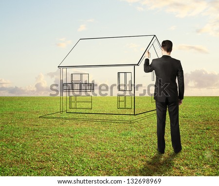 businessman drawing house on field background