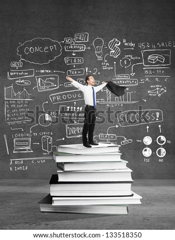 happiness businessman standing on books and drawing business concept