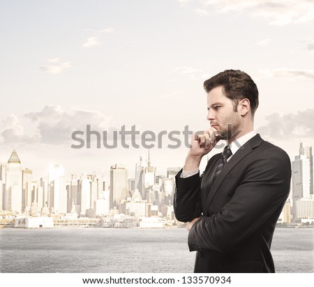businessman thinking and city on background