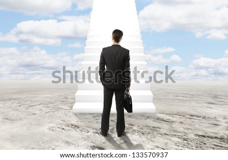 businessman looking at stairs to heaven
