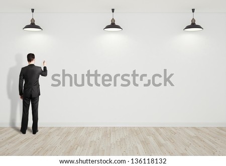 businessman drawing on white wall