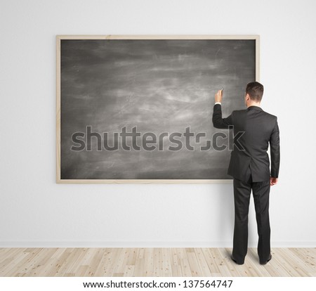 businessman drawing on blank blackboard