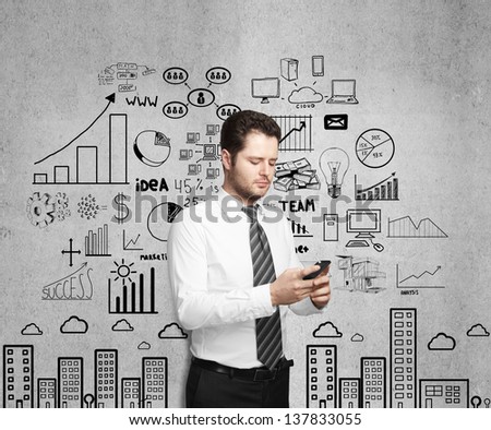 businessman holding phone and drawing  business strategy on wall