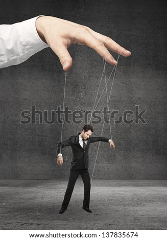 man marionette on ropes controlled  hand