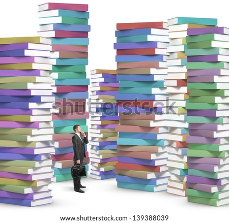 businessman with phone looking at stacks of books
