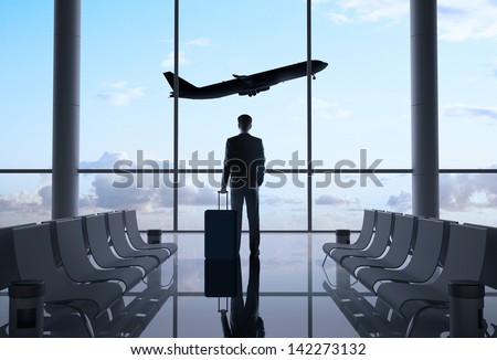Man In Airport And Airplane In Sky