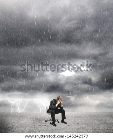 sad businessman sitting on rainy weather