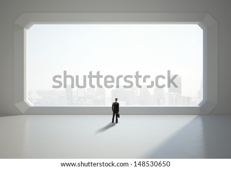 businessman standing near big window