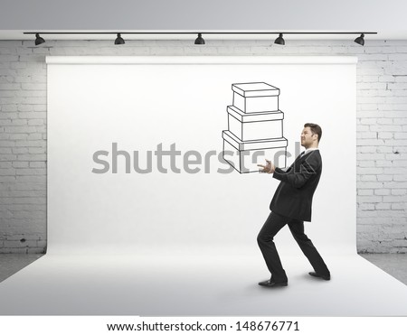 businessman holding drawing box in studio