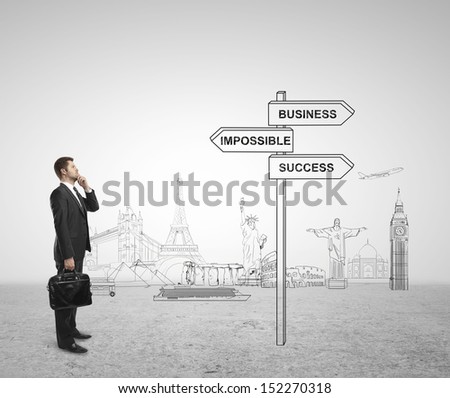 businessman looking at direction indicator, travel concept