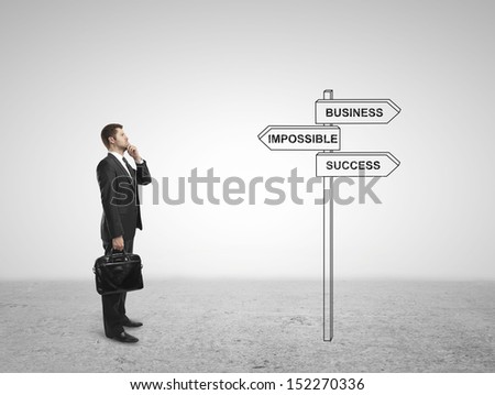 businessman looking at direction indicator