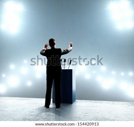 businessman standing on podium and closes on outbreaks businessman standing on podium and closes on outbreaks