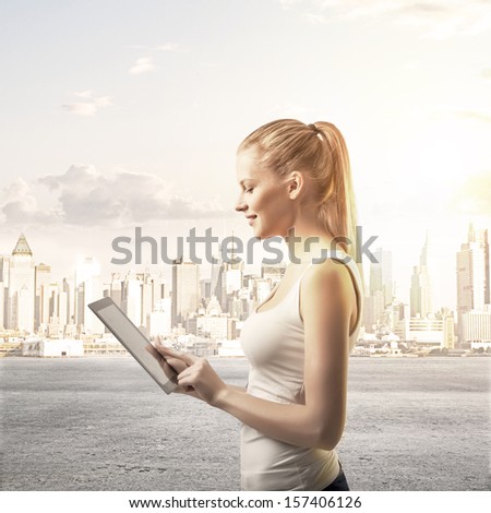 lady with  touch pad on city background