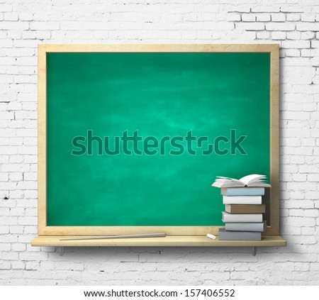 green blackboard and book on a brick wall