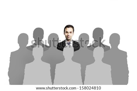 man standing among people silhouettes