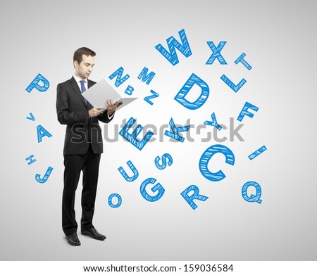 businessman holding book with many letters on gray background