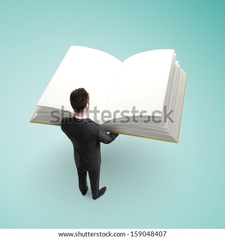 businessman holding big book on green background
