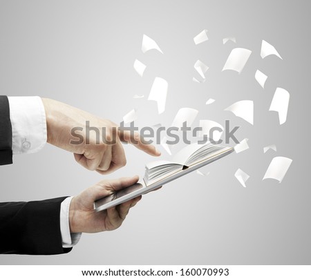 hands holding digital tablet with open book