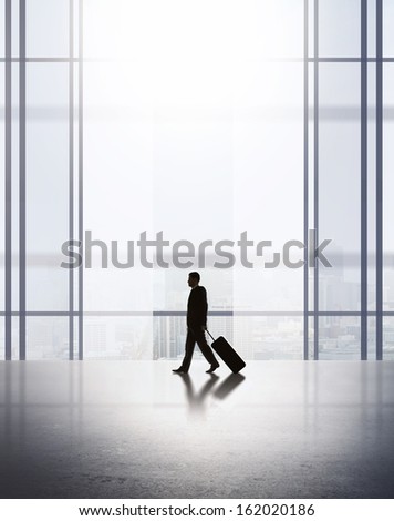businessman with luggage in airport