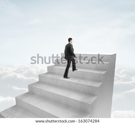 businessman climbing to stairs in cloud