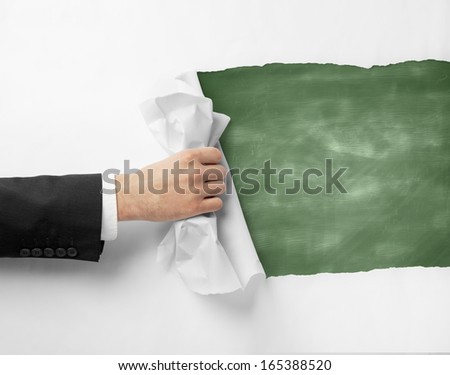 hand turns page to green blackboard