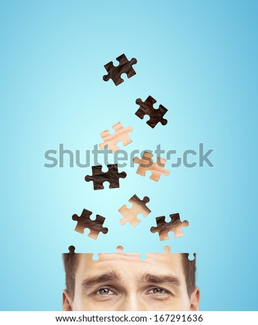 head businessman built of puzzle on blue background