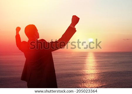 happy businessman looking at sunrise