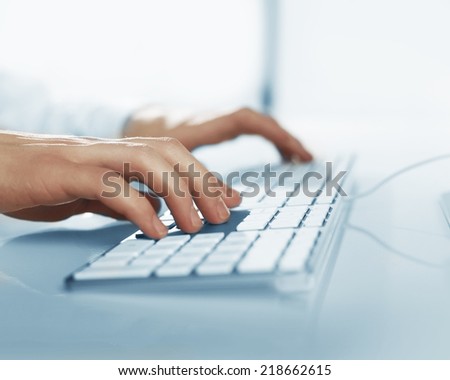 busienssman hands pushing keys of computer, close up