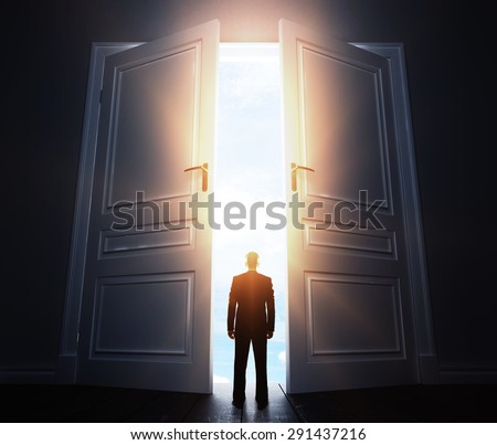 businessman in room with big open door