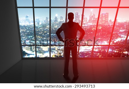 businessman in office looking to night city
