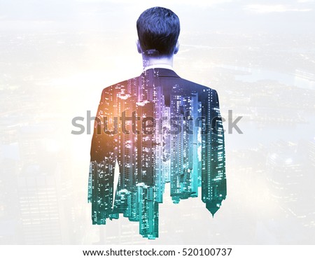 Back view of thoughtful businessman on night city background. Double exposure. Research concept