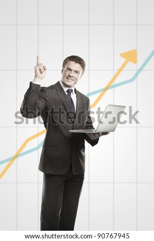 Happy young business man with laptop showing thumbs up. On a gray background with rising arrow, representing business growth